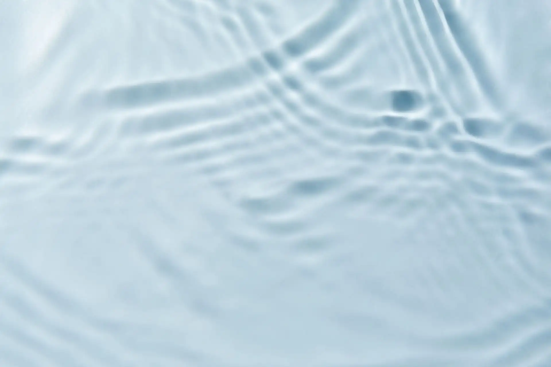 Gentle ripples on the surface of clear blue water