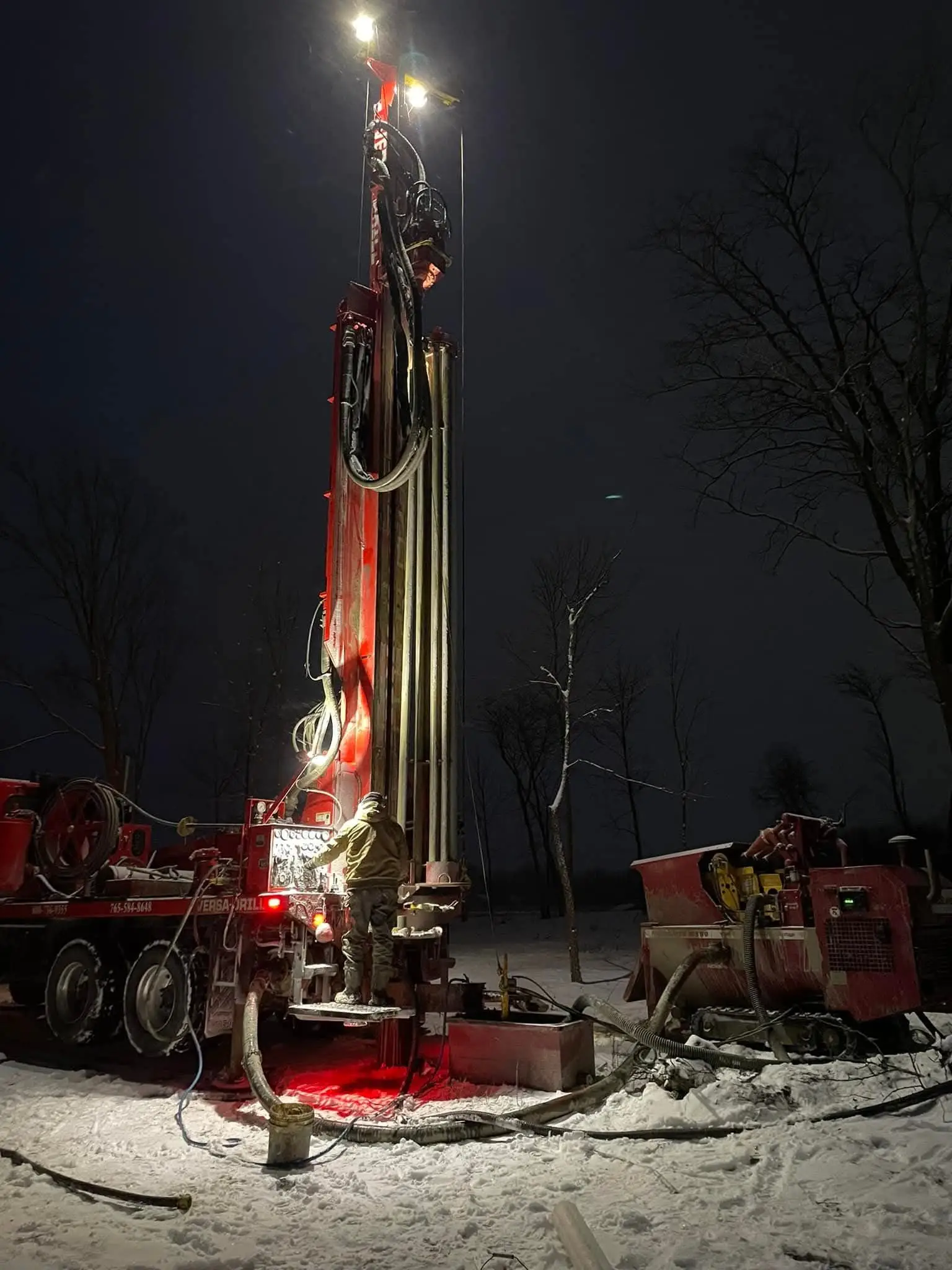 Close-up of a drill bit boring into the ground at a well drilling site