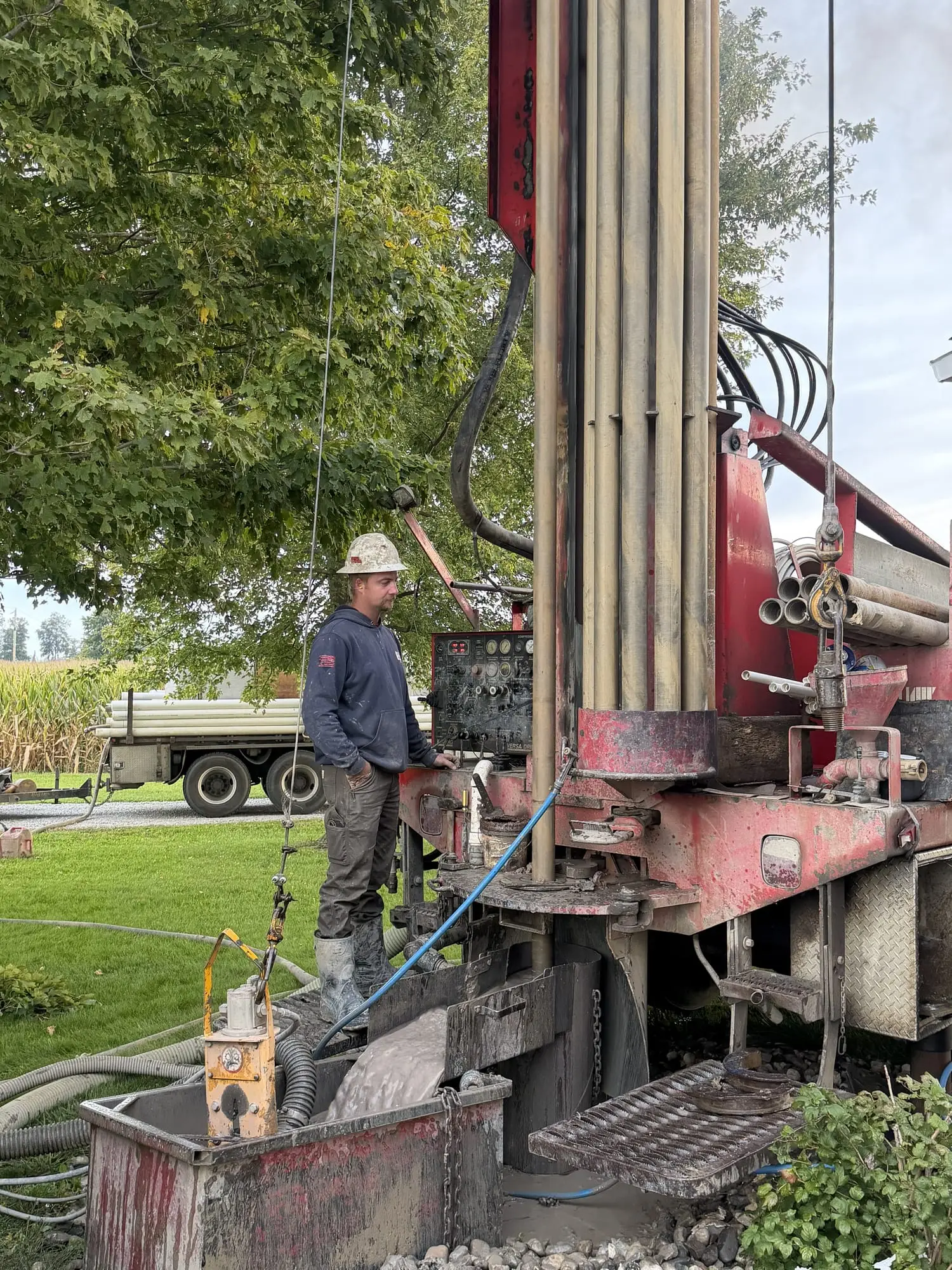 A Wiley Well Drilling crew member working the controls of a drilling rig